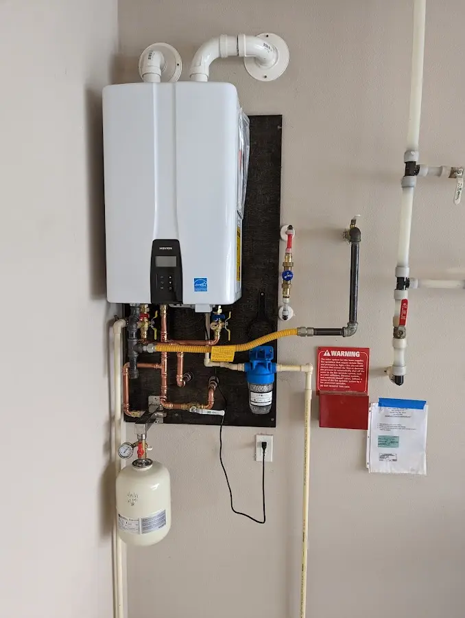 Professional plumber installing copper piping in a Westminster home